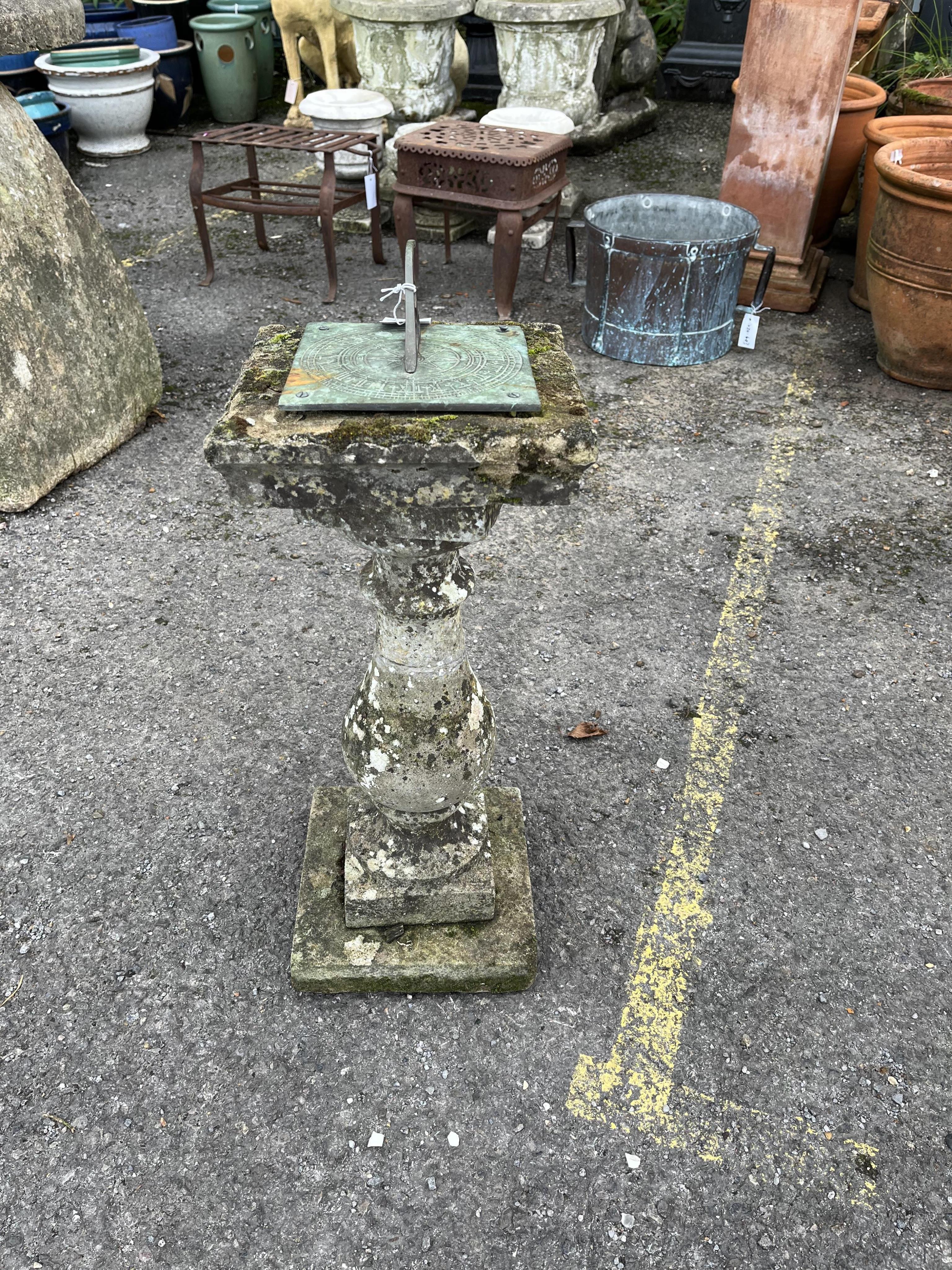 A reconstituted stone sun dial, height 64cm. Condition - weathered, otherwise good